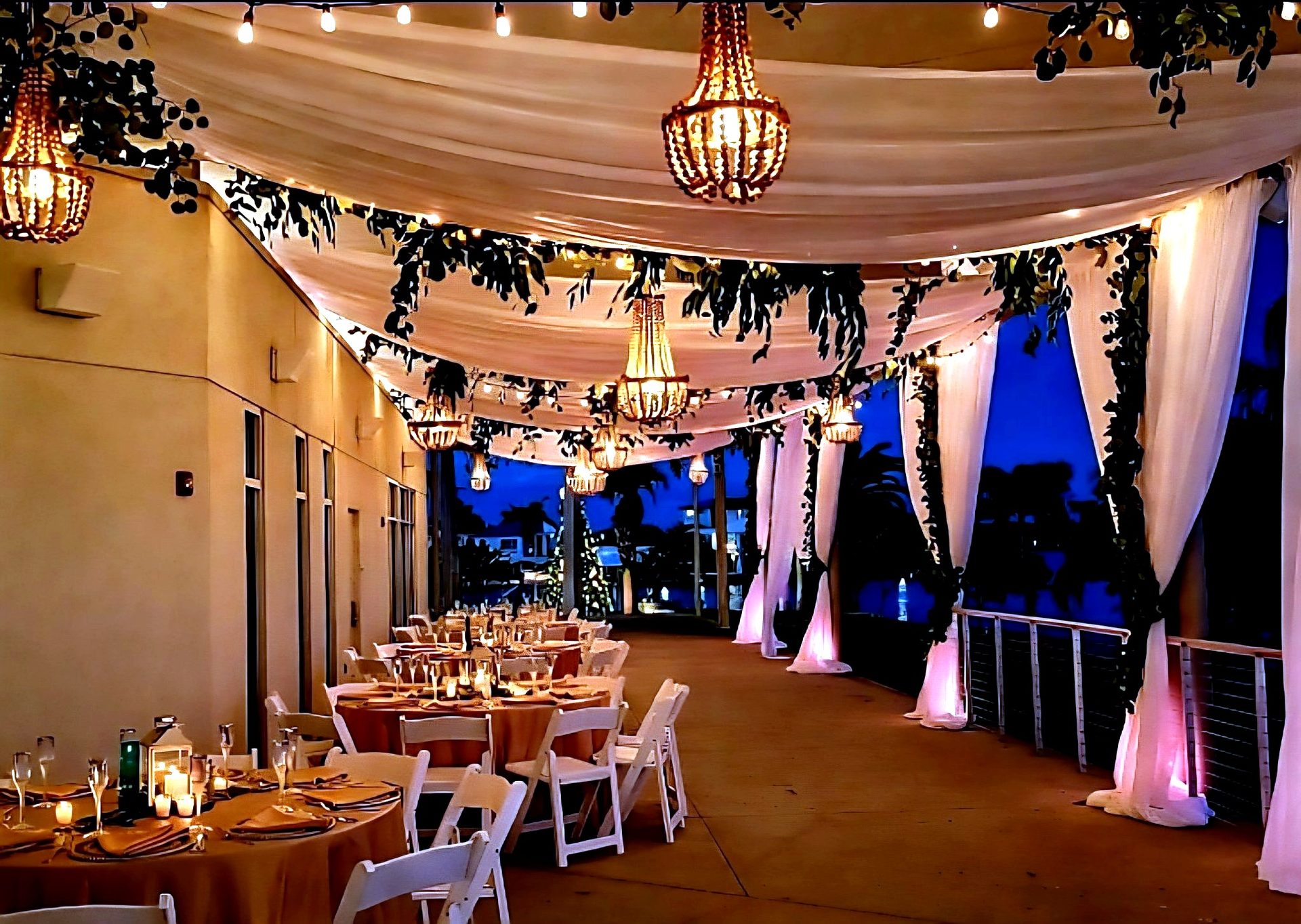 Pipe & drape — draped waterfront walkway with pink uplighting on the drape columns, by Altitude Event Design and Decor, Tampa Bay